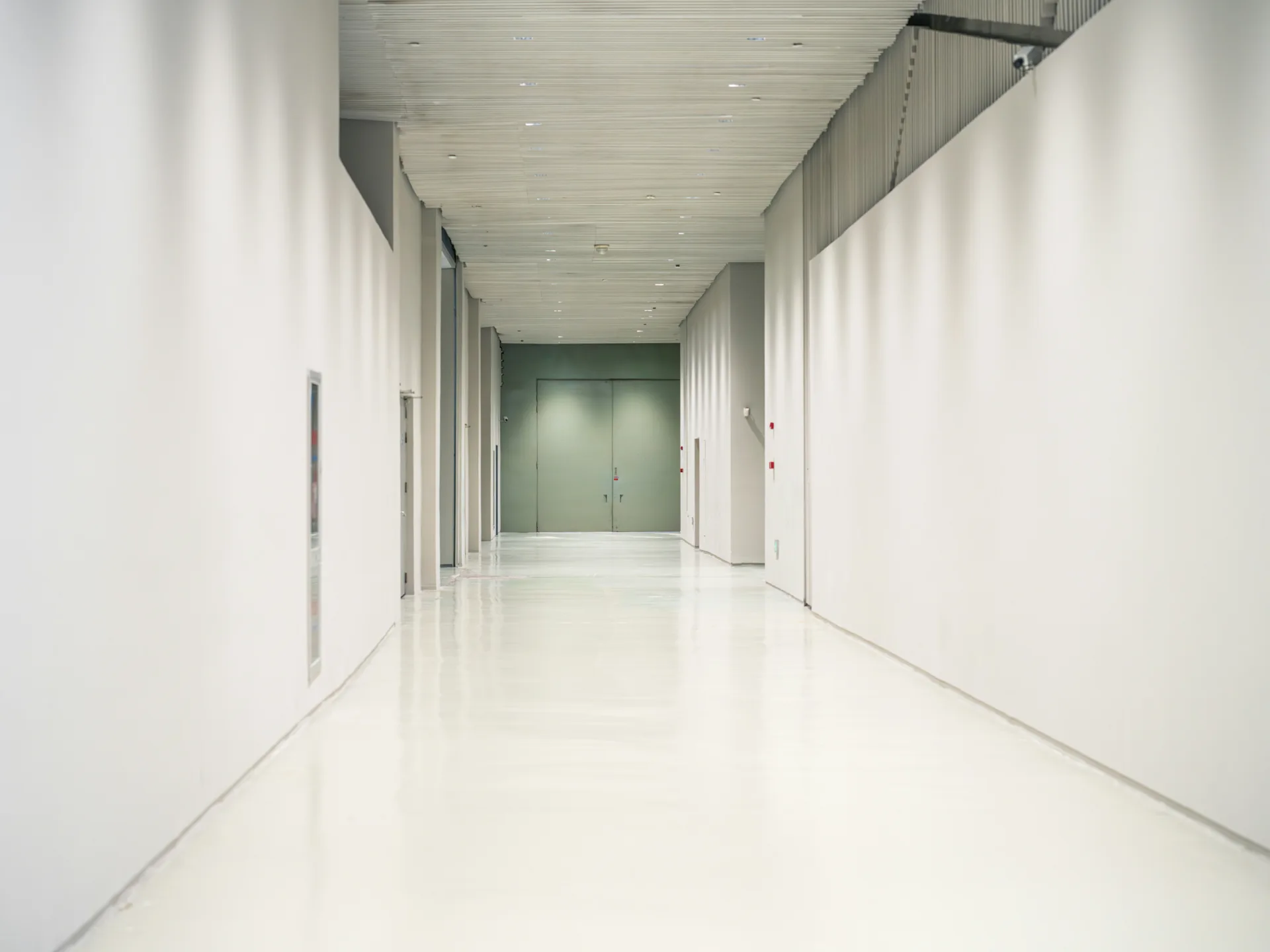 white epoxy commercial floor in a Laval corridor