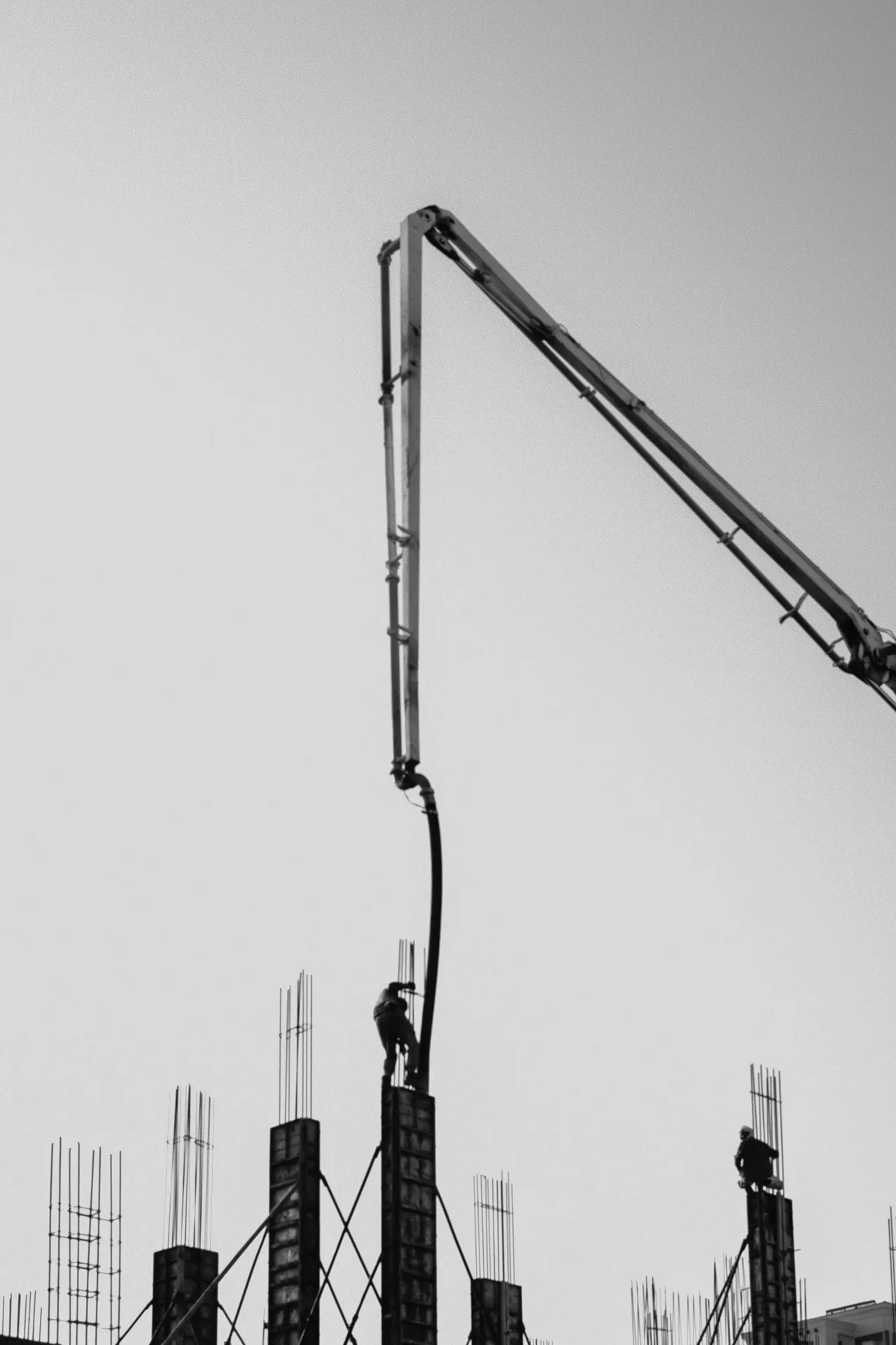 concrete pump and rebar on a tilt-up construction site in Laval