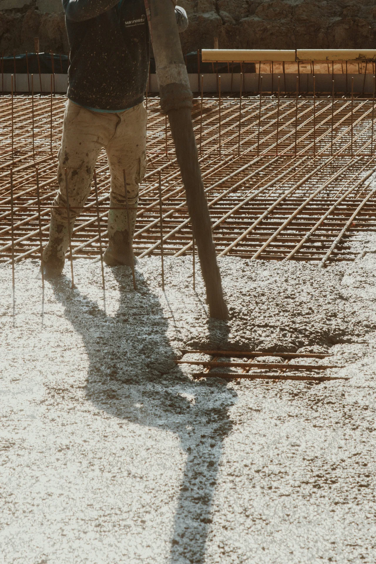 concrete pump hose placing concrete over a Laval rebar mat