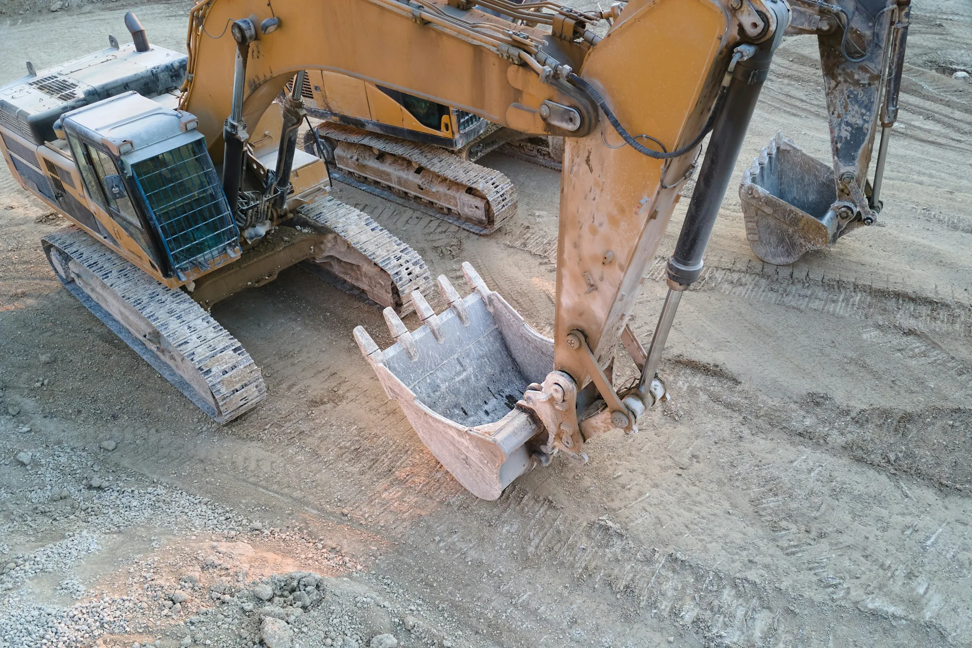 excavator working on a heavy-equipment concrete pad in Laval