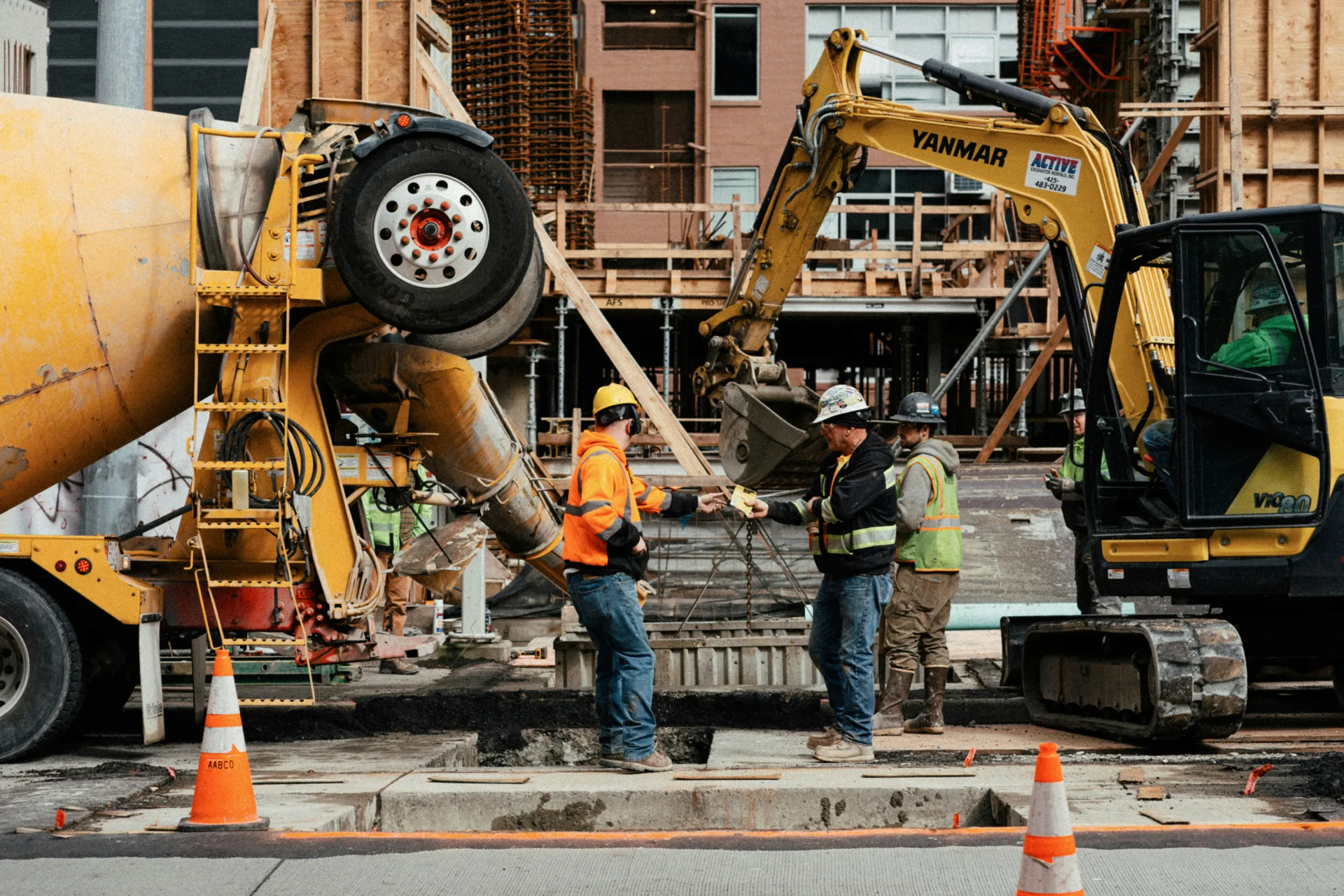 ready mix concrete pour on a Laval urban site with a mini excavator