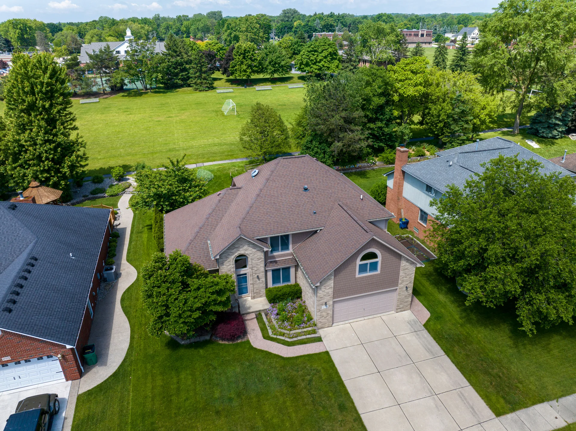 aerial view of brushed-finish concrete driveways in a Laval suburb