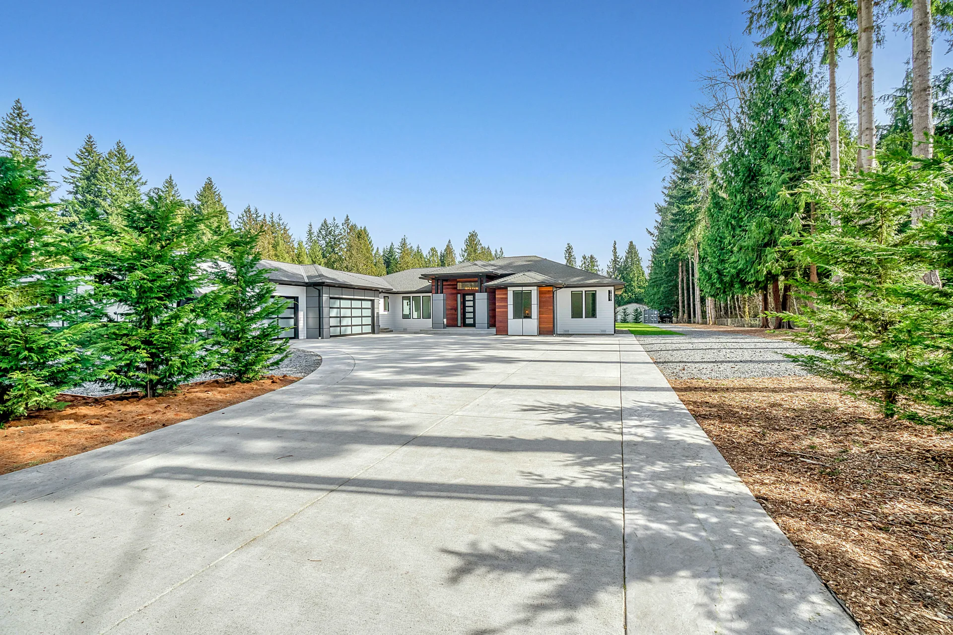 long coloured concrete driveway at a Laval home