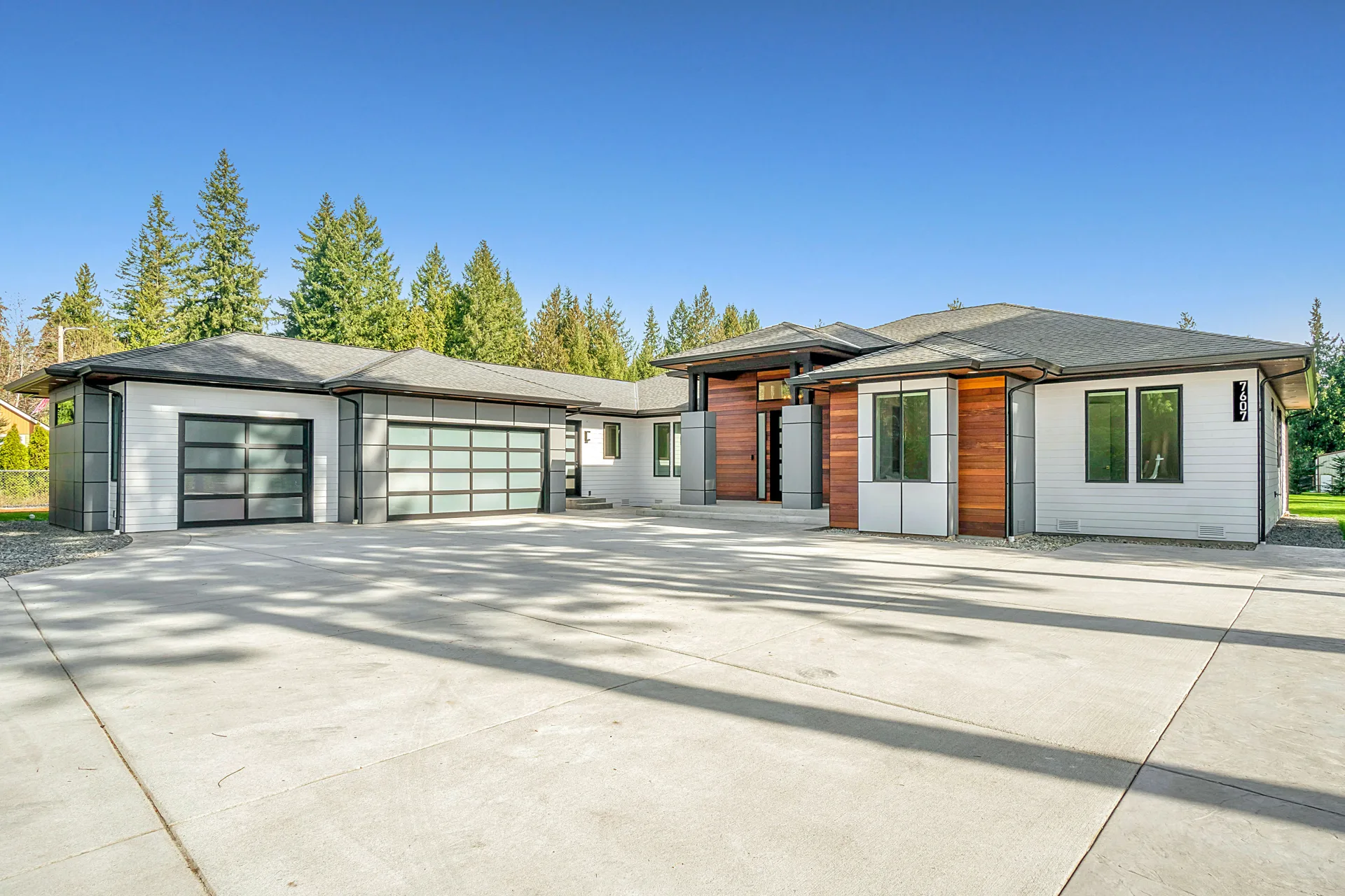 new concrete driveway at a modern three-car-garage Laval home