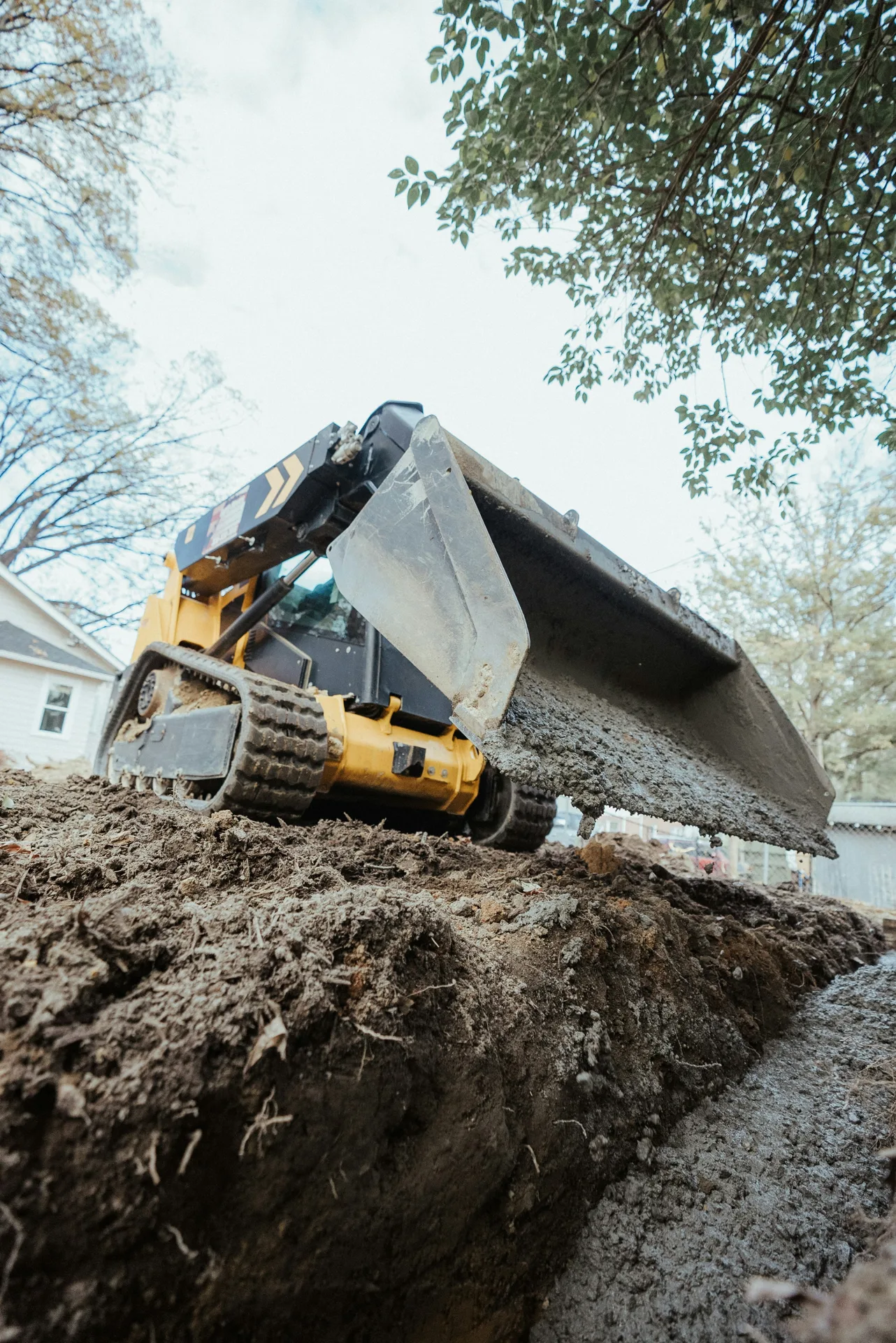 foundation repair pour with a track loader in Laval