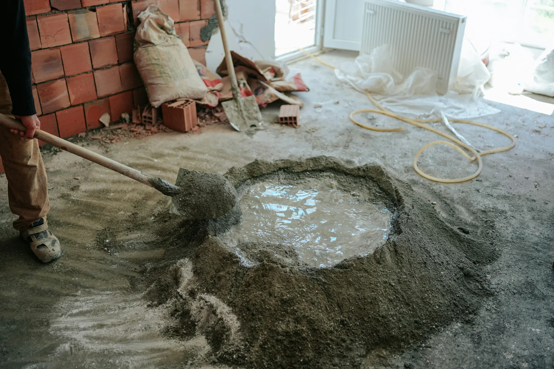 mixing self-leveling compound on a Laval renovation site