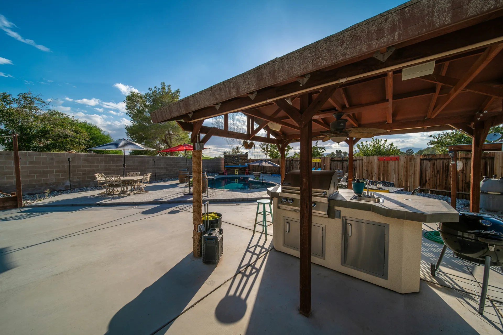 broom-finish concrete pad around a fire pit at a Laval home