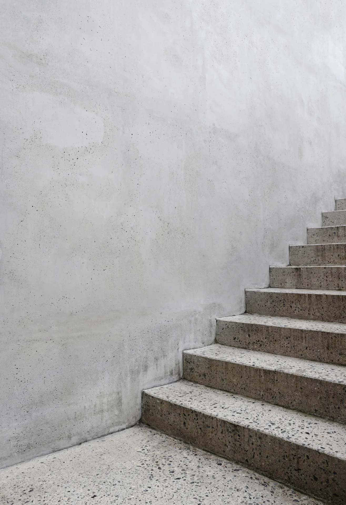 finished concrete front entry steps at a Laval home in winter